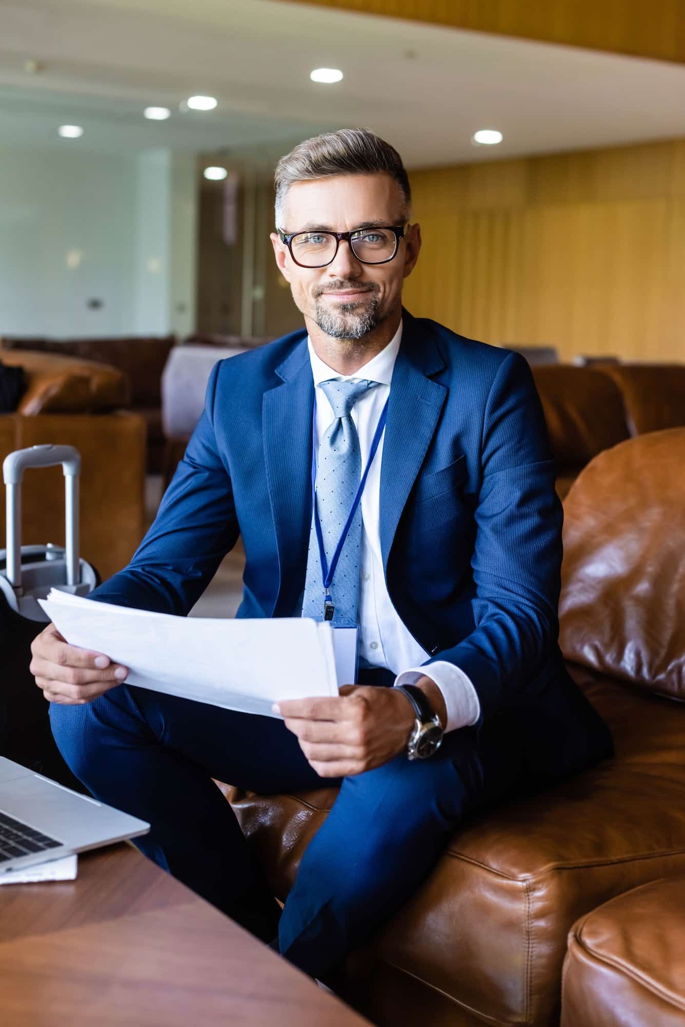 handsome businessman in formal wear and glasses holding documents 1